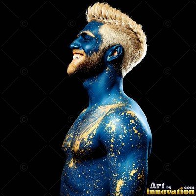 Smiling against black, a shirtless man is covered in blue paint and gold flecks