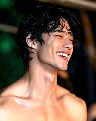 Outdoors in soft light, a shirtless man with wet black hair laughs with eyes closed