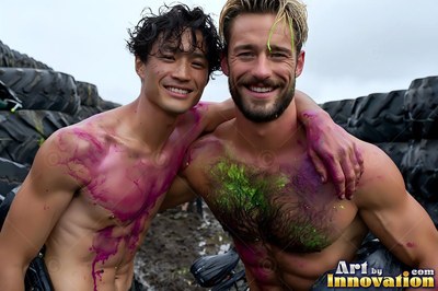 Two shirtless men grin together outdoors with pink and green paint smeared on their chests