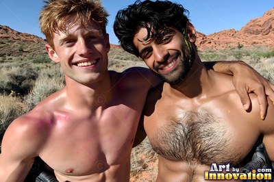 Two bare-chested men grin together outdoors with pink paint splattered on pale skin under bright sun