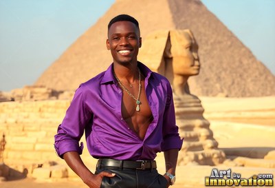 Smiling man dressed in an open purple silk shirt by the Sphinx and pyramid