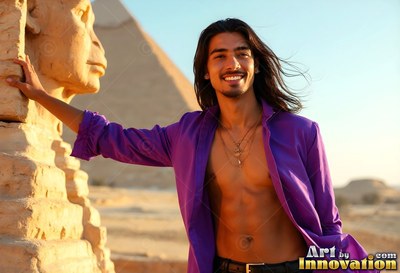 Wearing an open purple soft silk shirt, a smiling young man poses by the Sphinx statue