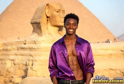 Smiling man with an open dark purple shirt by the Great Sphinx