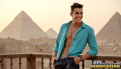 Smiling on a balcony, a younger man wears an open dark teal shirt before the Giza pyramids