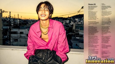 A bright pink unbuttoned shirt on a smiling young man sitting on a tokyo rooftop at dusk