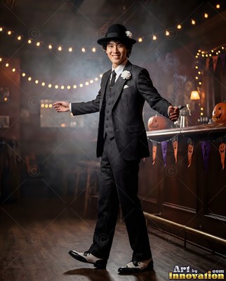 A man with a smile in a dark pinstripe suit and bowler hat poses in a dimly lit bar