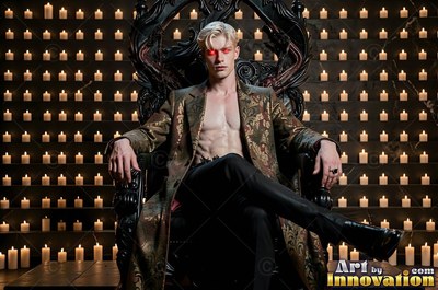 Before a wall of small candles, a blond man sits on a black carved throne