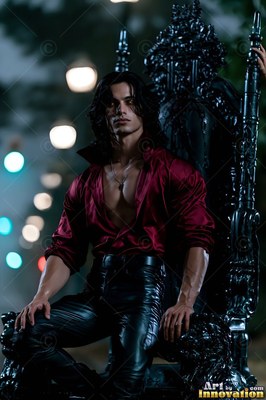 Sitting on a black throne, a dark-haired man wears an open red shirt and leather pants