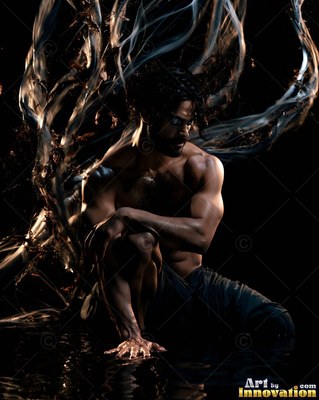 Crouching in dark water, a shirtless man summons pale swirling streams of smoke