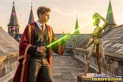 Aiming a green light beam, a young man in red robes points a wand at a wooden dummy