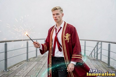 On a misty deck, a blond man in a bright red robe holds a wand shooting sparks