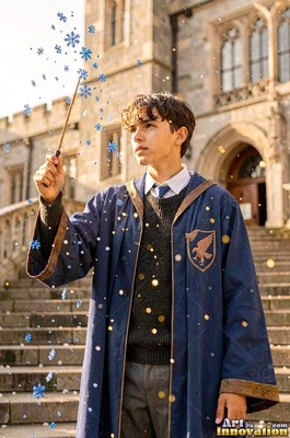 Standing on stone steps, a young man raises a wand in a blue robe outside a castle