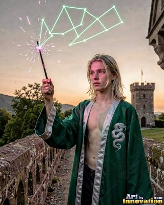 A blond young man wearing an unbuttoned green robe holds up a wand by a stone castle wall