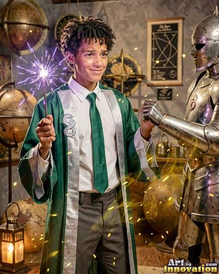 Young man wearing a deep green robe holding a sparking wand by armor
