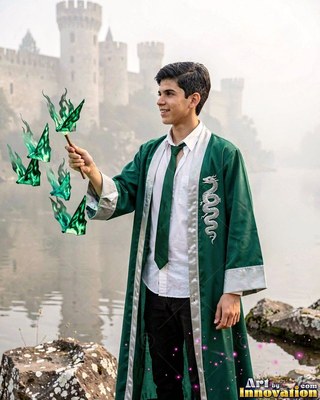 A young man in a green robe raises a wand casting green flames in pale gray light