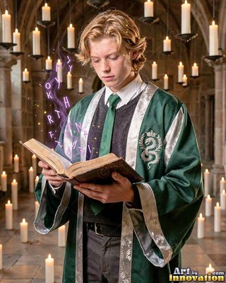 In a candlelit stone hall, a young blond man reads an open spellbook in green robes