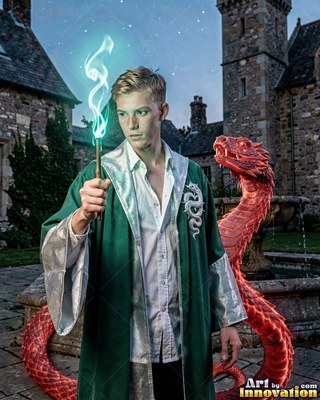 Holding a lit wand, a young man in a green robe stands beside a red horned snake