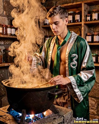 Young man stirs a steaming cauldron in an open loose green robe