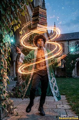 A man in an open green gown levitates books with two wands in a courtyard