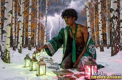 A bare-chested man dressed in a parted green robe lights lanterns in the snow under lightning