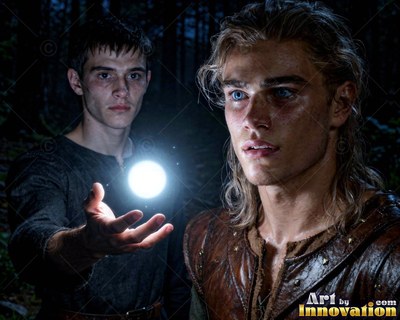 Two men in the dark woods watching a bright white ball of light