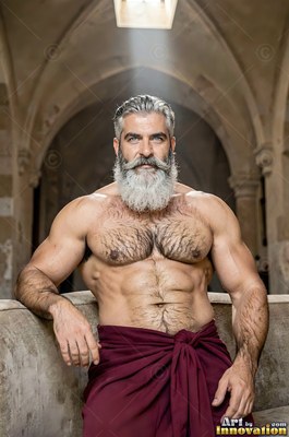 Under a stone arch, a shirtless man with a full gray beard wears a red cloth around his waist