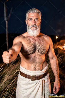 Standing facing forward in a dark field, a bearded man holds out a metal rod