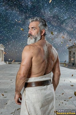 Man with a beard draped in a white tunic under a starry night sky