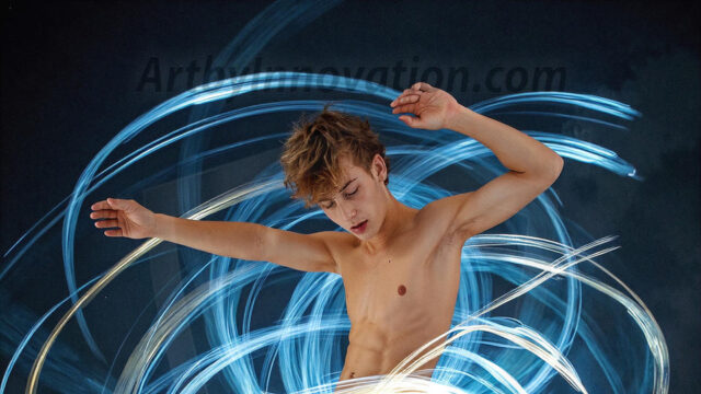 Abstract Male Art, AI photos of handsome shirtless men dancing with Light Rays, colorful art in motion. Guys dancing with radiant light rays that wrap around his body in flowing patterns, emphasizing his movements and adding a sense of ethereal fluidity. The designs appear weightless and almost sculptural, creates a striking contrast against the backgrounds making him the center of a cosmic dance, with energy and elegance. AI-generated abstract art HD photos featuring handsome, sexy, shirtless, men, boys, lads, dancing with colorful light rays, dynamic, interactive. Combining elements of realism with surreal abstract qualities, showcasing the potential of AI in artistic expression.