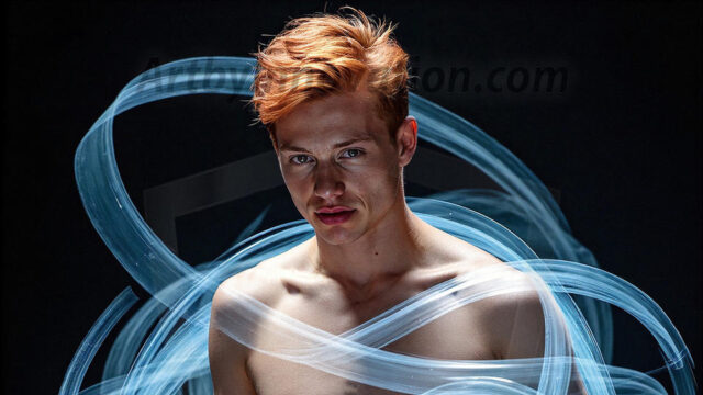 Abstract Male Art, AI photos of handsome shirtless men dancing with Light Rays, colorful art in motion. Guys dancing with radiant light rays that wrap around his body in flowing patterns, emphasizing his movements and adding a sense of ethereal fluidity. The designs appear weightless and almost sculptural, creates a striking contrast against the backgrounds making him the center of a cosmic dance, with energy and elegance. AI-generated abstract art HD photos featuring handsome, sexy, shirtless, men, boys, lads, dancing with colorful light rays, dynamic, interactive. Combining elements of realism with surreal abstract qualities, showcasing the potential of AI in artistic expression.