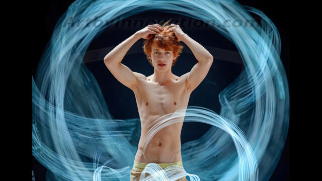 Abstract Male Art, AI photos of handsome shirtless men dancing with Light Rays, colorful art in motion. Guys dancing with radiant light rays that wrap around his body in flowing patterns, emphasizing his movements and adding a sense of ethereal fluidity. The designs appear weightless and almost sculptural, creates a striking contrast against the backgrounds making him the center of a cosmic dance, with energy and elegance. AI-generated abstract art HD photos featuring handsome, sexy, shirtless, men, boys, lads, dancing with colorful light rays, dynamic, interactive. Combining elements of realism with surreal abstract qualities, showcasing the potential of AI in artistic expression.