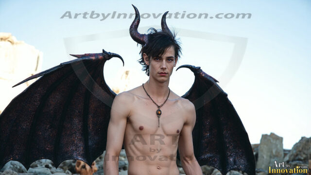 In a dark, ethereal realm, in the midst of the darkness, a figure emerges with an aura of power and magnetism. He is both horrific and strangely captivating, drawing the eye even as he repels the soul. His form is indistinct at first, a ripple in the oppressive blackness, you want to run but you become overwhelmed, drawn in to this creatures powers. Captative by both fear and beauty, you realize, he's a male succubus demon. Deep within the ruins of hell, with a sword in your hand, ready to battle, but unwilling or unable to do so. His skin, flickering fires, casting a dynamic glow across his glistening wet, shinny, body. The flames dance along his chiseled muscular torso and body, casting vibrant hues that seem to emanate from his very core. His eyes, have a piercing glow, locked in a gaze, his eyes, exudes confidence and authority. Unable to move, or unwilling to do so, drawn by his almost completely nude body and overwhelmed by his powers, you given to his will.