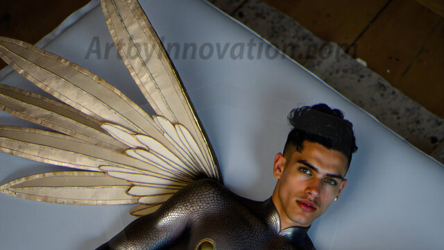 Brought to life through AI, Capturing the Pristine and Elusive Male Fairy. Imagine a realm where handsome shirtless men & boys possess enormous, shimmering crystal wings, vibrant and radiant, capturing and reflecting the light of the environment in a mesmerizing way, and adding a touch of mystery to their intense visage. Outdoors in a fantasy mysterious enchanted realm.