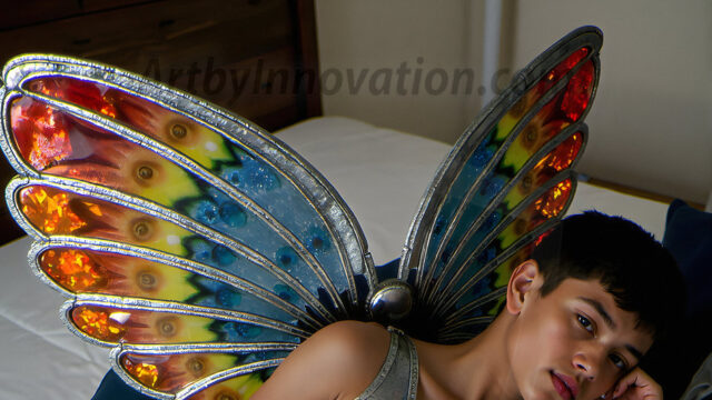 Brought to life through AI, Capturing the Pristine and Elusive Male Fairy. Imagine a realm where handsome shirtless men & boys possess enormous, shimmering crystal wings, vibrant and radiant, capturing and reflecting the light of the environment in a mesmerizing way, and adding a touch of mystery to their intense visage. Outdoors in a fantasy mysterious enchanted realm.