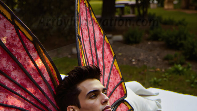 Brought to life through AI, Capturing the Pristine and Elusive Male Fairy. Imagine a realm where handsome shirtless men & boys possess enormous, shimmering crystal wings, vibrant and radiant, capturing and reflecting the light of the environment in a mesmerizing way, and adding a touch of mystery to their intense visage. Outdoors in a fantasy mysterious enchanted realm.