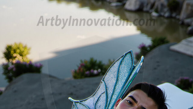 Brought to life through AI, Capturing the Pristine and Elusive Male Fairy. Imagine a realm where handsome shirtless men & boys possess enormous, shimmering crystal wings, vibrant and radiant, capturing and reflecting the light of the environment in a mesmerizing way, and adding a touch of mystery to their intense visage. Outdoors in a fantasy mysterious enchanted realm.