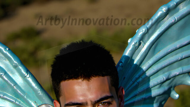 Brought to life through AI, Capturing the Pristine and Elusive Male Fairy. Imagine a realm where handsome shirtless men & boys possess enormous, shimmering crystal wings, vibrant and radiant, capturing and reflecting the light of the environment in a mesmerizing way, and adding a touch of mystery to their intense visage. Outdoors in a fantasy mysterious enchanted realm.