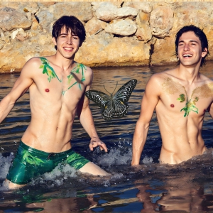 The Beautiful & Handsome Men Art Collection, A high-resolution photograph of two handsome best friends, half submerged in water, covered in body paint. Butterfly's flying about, as they spend time together, with a smile on their faces.