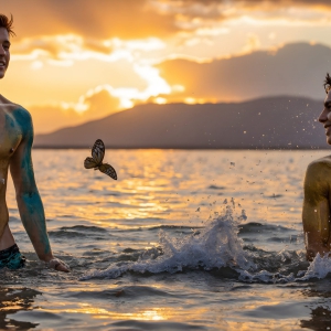 The Beautiful & Handsome Men Art Collection, A high-resolution photograph of two handsome best friends, half submerged in water, covered in body paint. Butterfly's flying about, as they spend time together, with a smile on their faces.