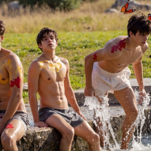 The Beautiful & Handsome Men Art Collection, A high-resolution photograph of two handsome best friends, half submerged in water, covered in body paint. Butterfly's flying about, as they spend time together, with a smile on their faces.