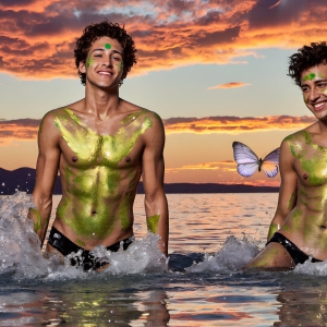 The Beautiful & Handsome Men Art Collection, A high-resolution photograph of two handsome best friends, half submerged in water, covered in body paint. Butterfly's flying about, as they spend time together, with a smile on their faces.