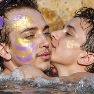 The Beautiful & Handsome Men Art Collection, A high-resolution photograph of two handsome best friends, half submerged in water, covered in body paint. Butterfly's flying about, as they spend time together, with a smile on their faces.