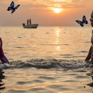 The Beautiful & Handsome Men Art Collection, A high-resolution photograph of two handsome best friends, half submerged in water, covered in body paint. Butterfly's flying about, as they spend time together, with a smile on their faces.