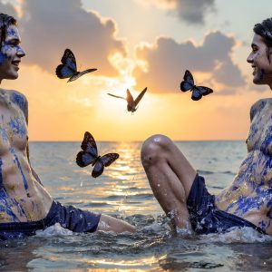 The Beautiful & Handsome Men Art Collection, A high-resolution photograph of two handsome best friends, half submerged in water, covered in body paint. Butterfly's flying about, as they spend time together, with a smile on their faces.