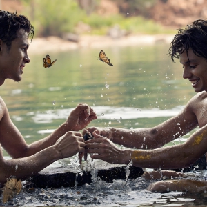 The Beautiful & Handsome Men Art Collection, A high-resolution photograph of two handsome best friends, half submerged in water, covered in body paint. Butterfly's flying about, as they spend time together, with a smile on their faces.