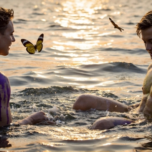 The Beautiful & Handsome Men Art Collection, A high-resolution photograph of two handsome best friends, half submerged in water, covered in body paint. Butterfly's flying about, as they spend time together, with a smile on their faces.