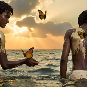 The Beautiful & Handsome Men Art Collection, A high-resolution photograph of two handsome best friends, half submerged in water, covered in body paint. Butterfly's flying about, as they spend time together, with a smile on their faces.