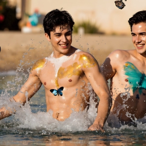 The Beautiful & Handsome Men Art Collection, A high-resolution photograph of two handsome best friends, half submerged in water, covered in body paint. Butterfly's flying about, as they spend time together, with a smile on their faces.