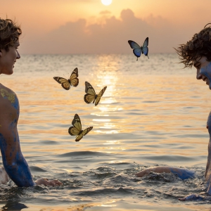 The Beautiful & Handsome Men Art Collection, A high-resolution photograph of two handsome best friends, half submerged in water, covered in body paint. Butterfly's flying about, as they spend time together, with a smile on their faces.