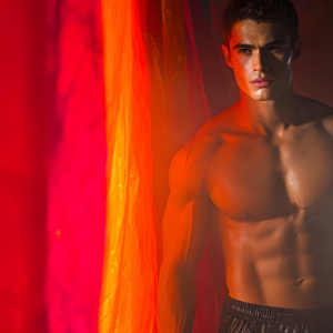 AI-generated art capturing men in a rainbow of colors creates a striking visual impact, blending surreal, vibrant, and high-fashion elements. Featuring artwork of beautiful, shirtless, muscular men embellished with or surrounded by a vibrant rainbow palette, evoking themes of pride, vitality, and artistic expression.